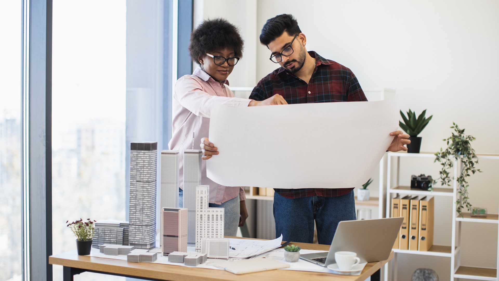 Architects reviewing real estate development plans